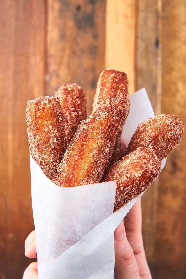 close up of golden brown blackberry lavender churros coated in cinnamon sugar