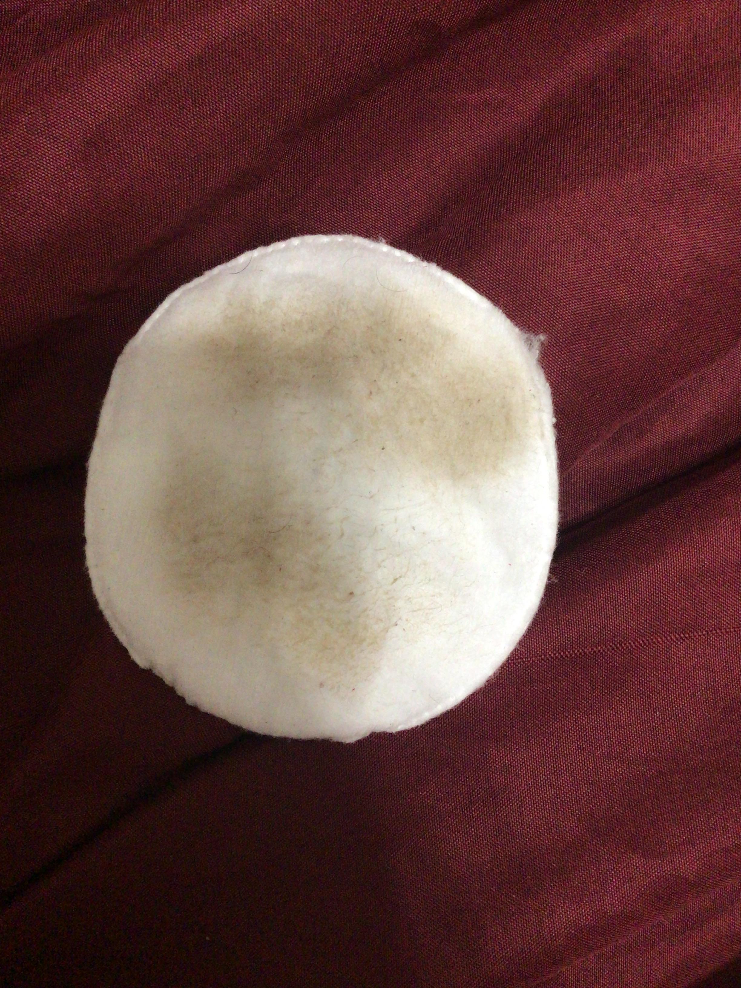 close-up of kombucha toner being sprayed on a cotton pad