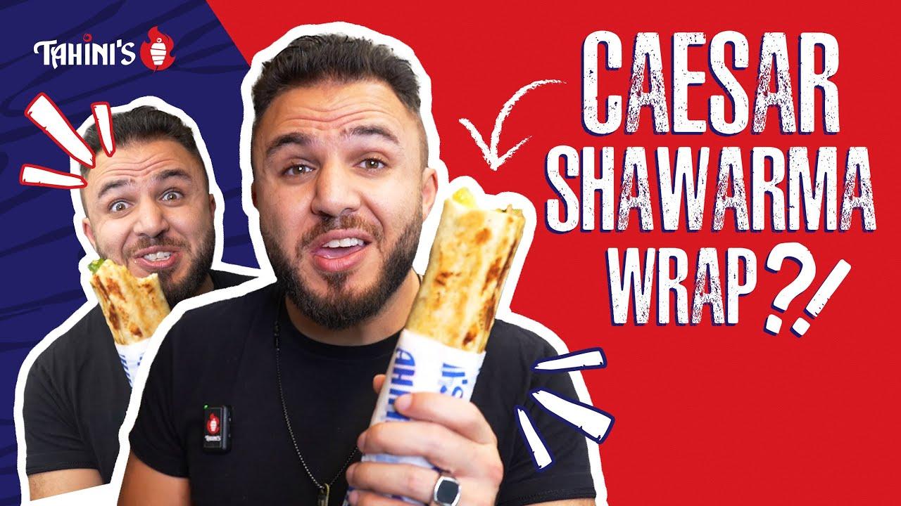 a person happily eating a tahini shawarma wrap