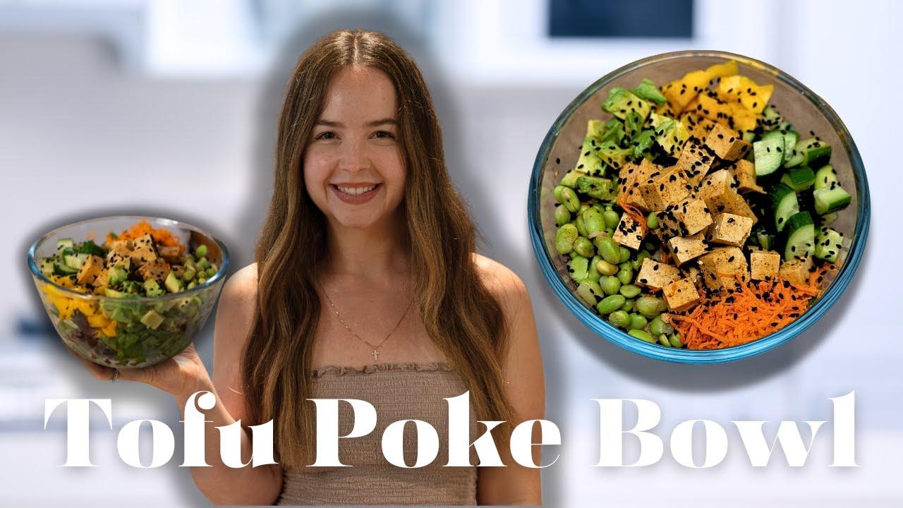 Overhead shot of a person preparing a tofu poke bowl with various ingredients