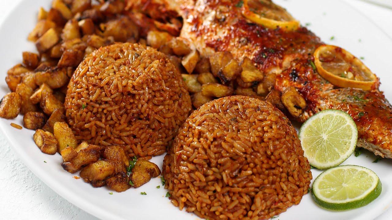 A plate of Spiced Jollof Rice Dream served with grilled chicken and plantains