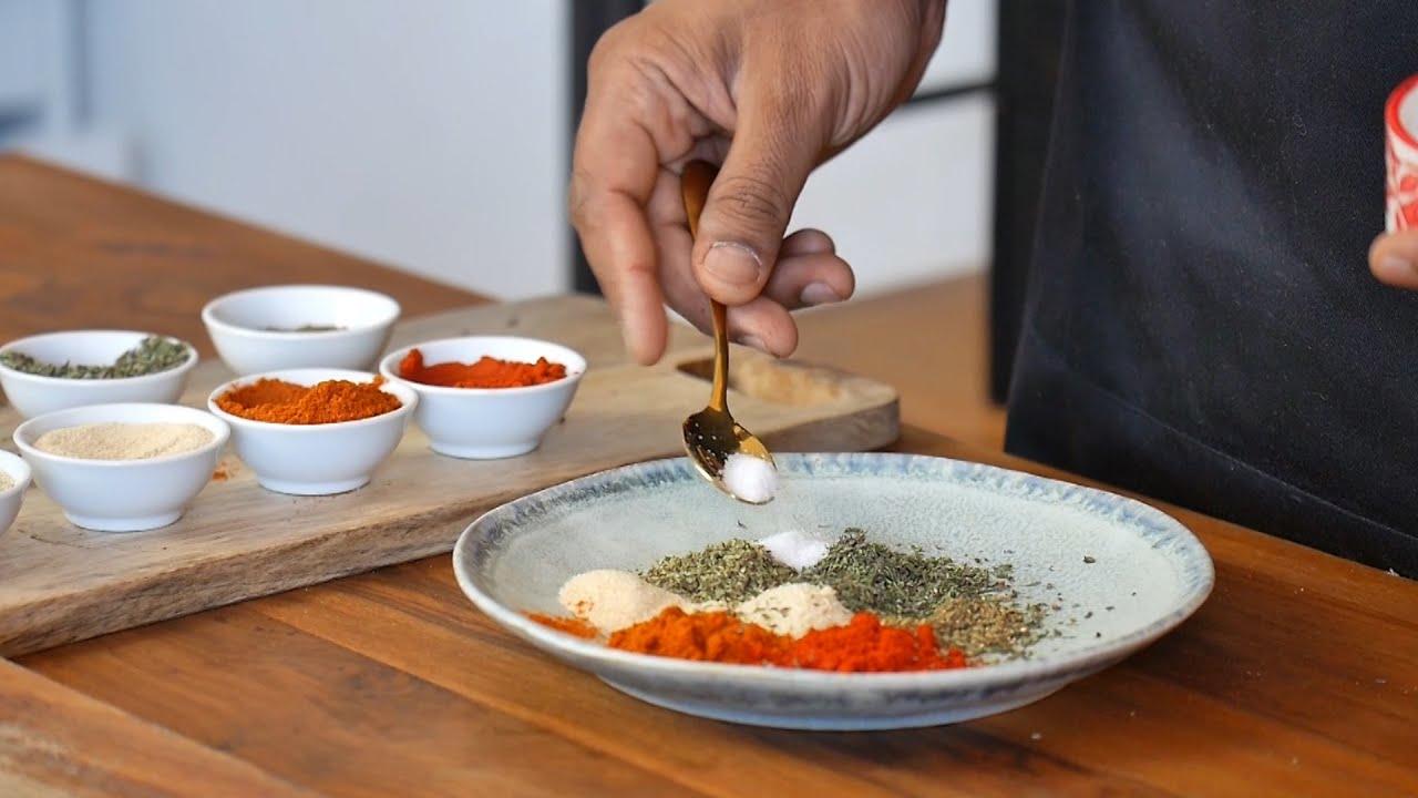 person cooking with spices