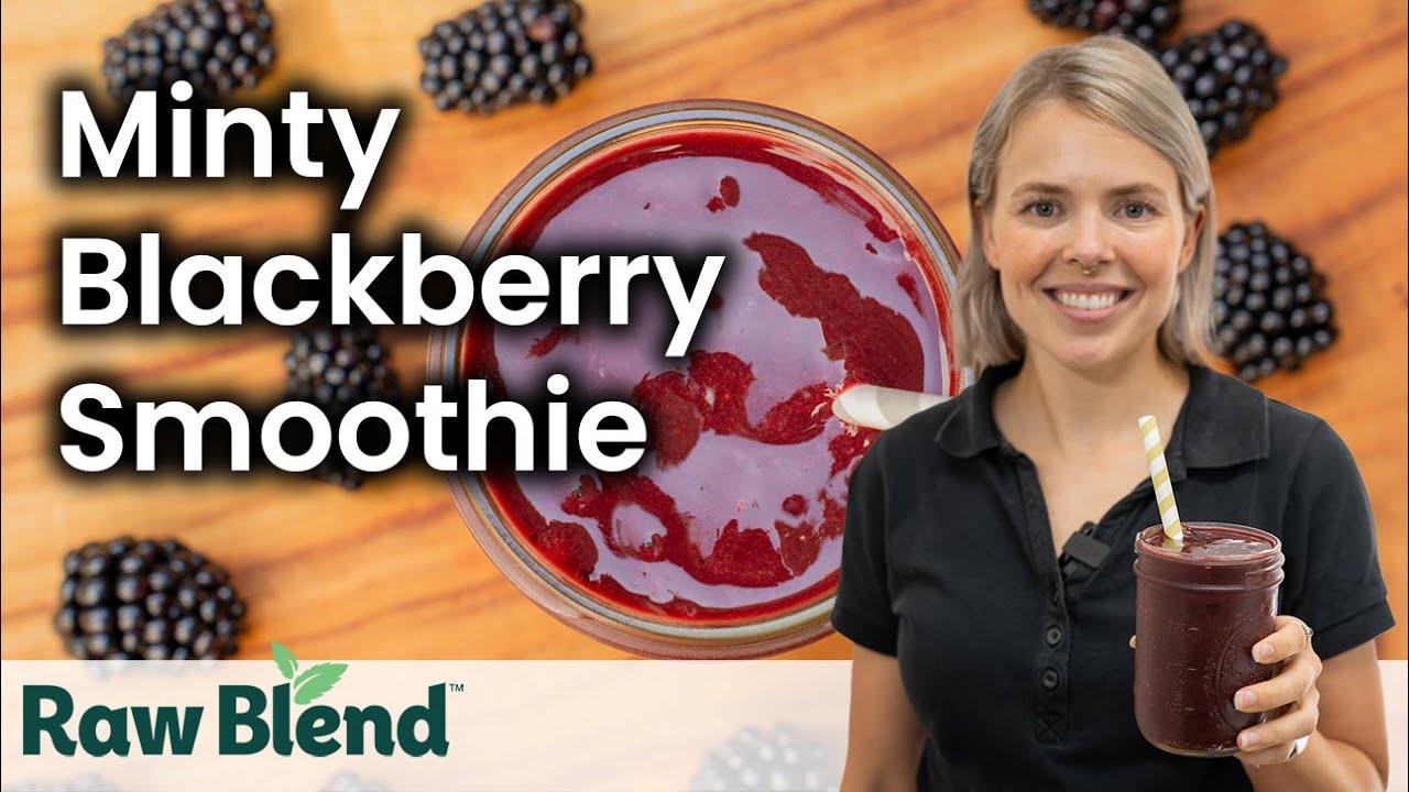 A blender in action, blending a blackberry smoothie.