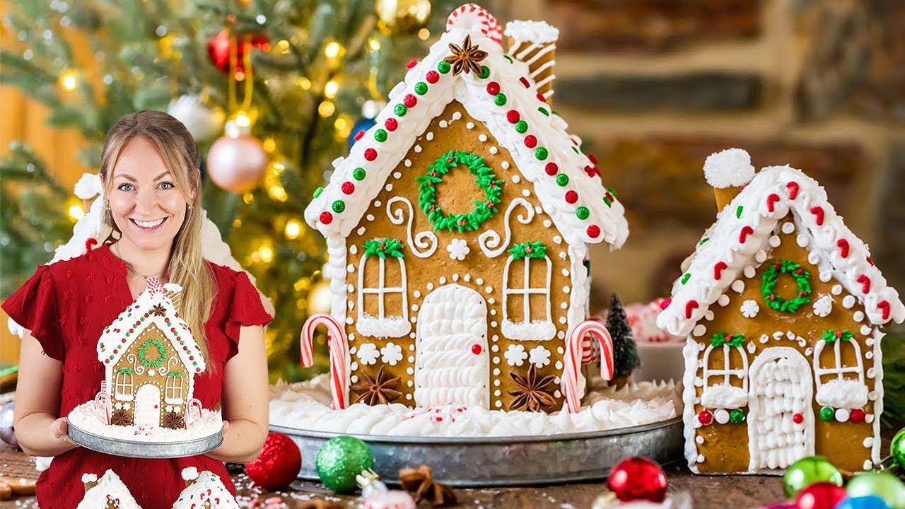 family decorating a soft gingerbread house together