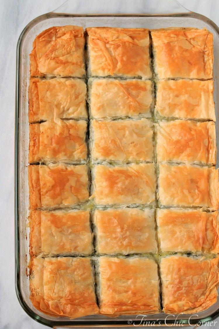 golden spanakopita flakes on a baking sheet