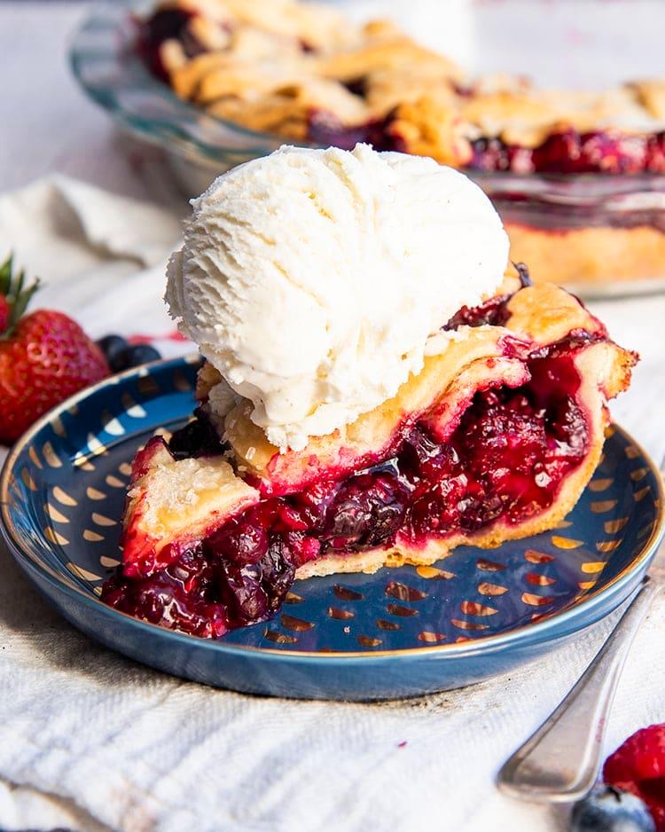 slice of berry pie with ice cream