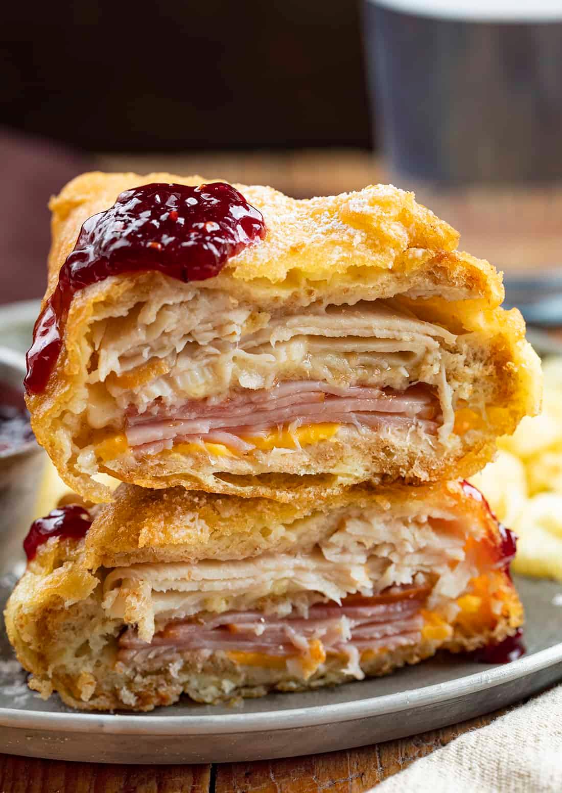 Close-up of a Monte Cristo Pancake showing the layers of ham, turkey, and Swiss cheese