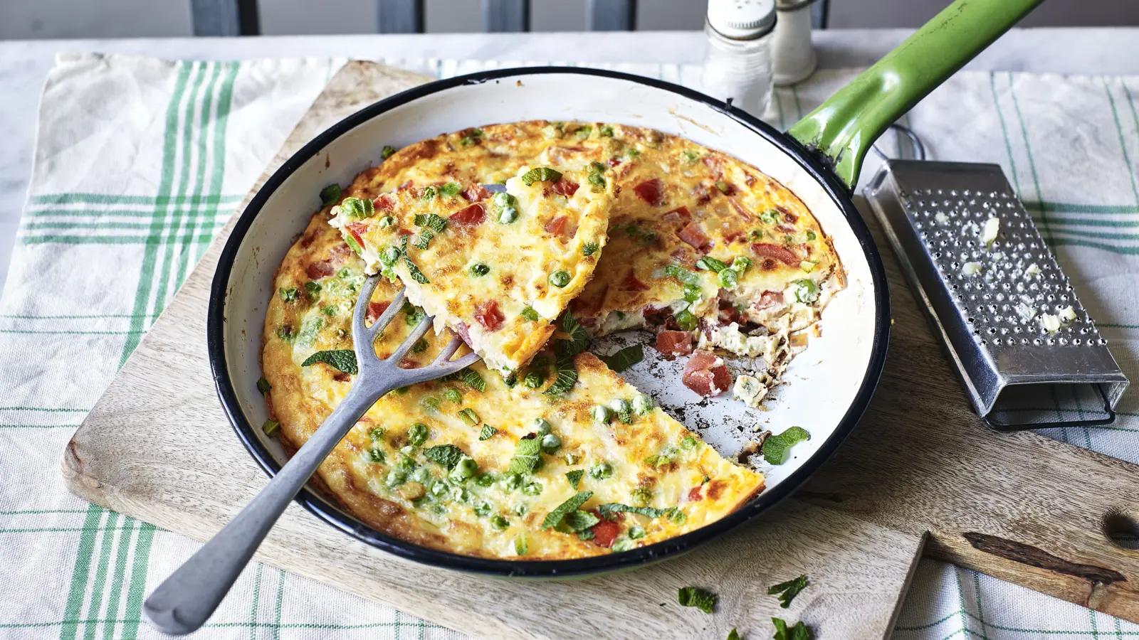 Frittata being cooked in a pan, showcasing the watermelon rind and mint