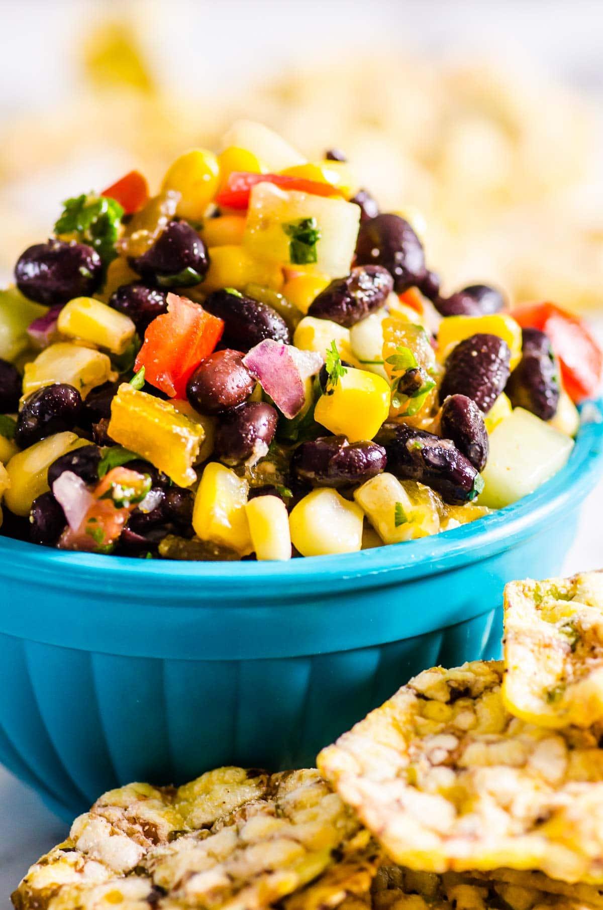 A person enjoying a roti filled with black bean corn salsa