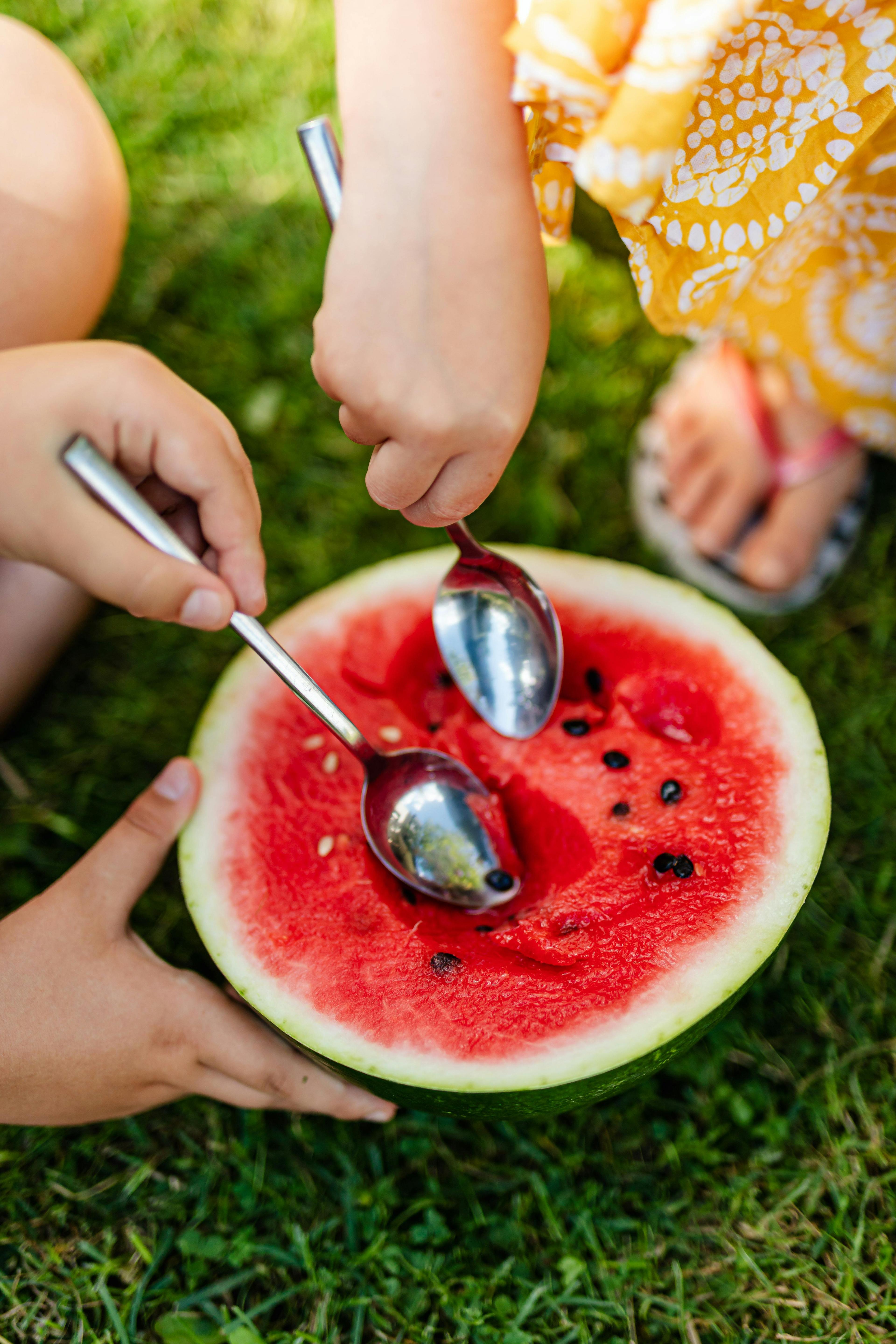 a person serving watermelon salsa with a spoon