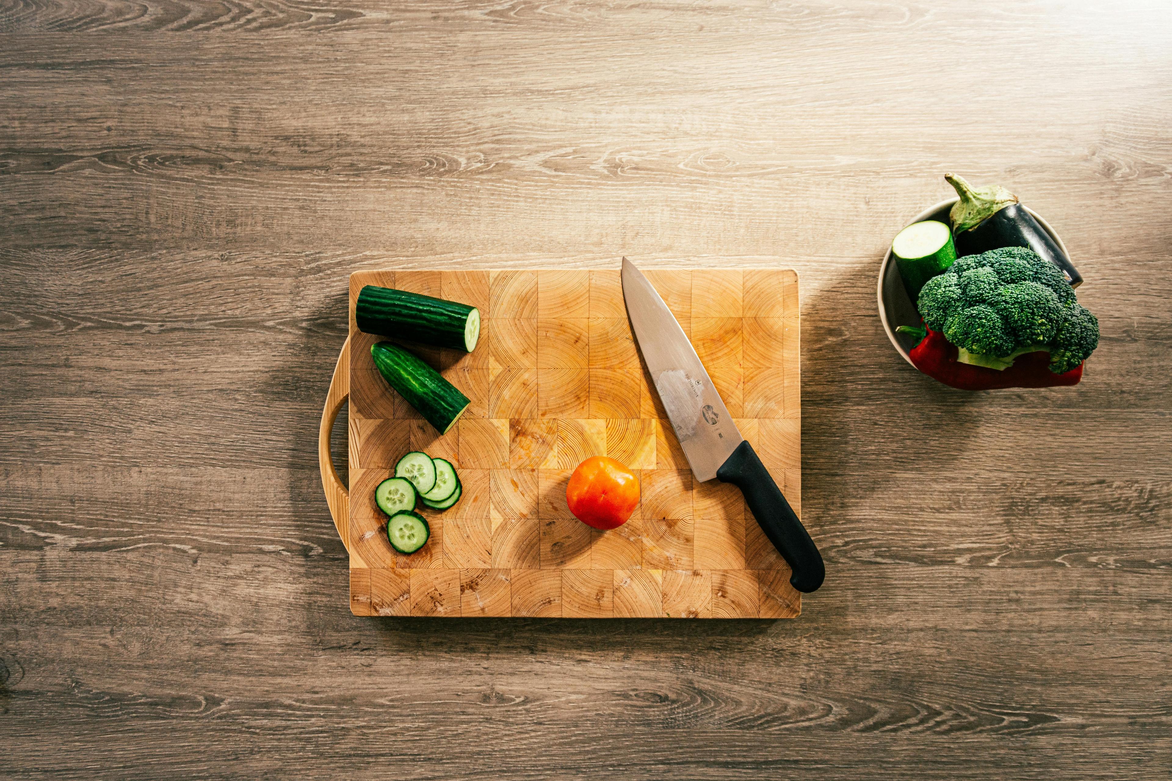 close-up shot of root vegetables being chopped on a cutting board