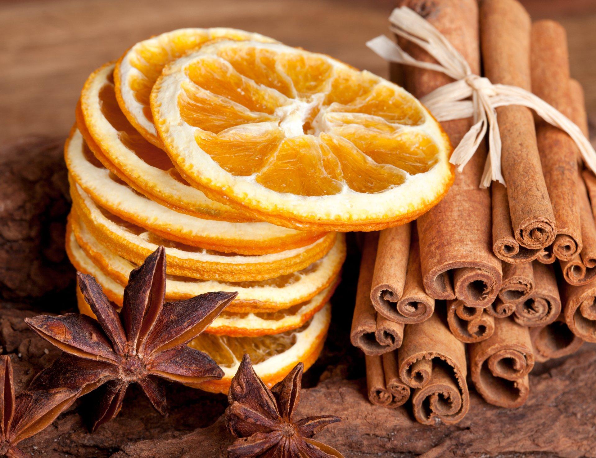 Close-up of fresh oranges, lemons, limes, cinnamon sticks, and star anise arranged beautifully