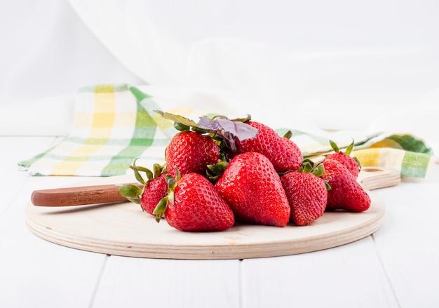 Fresh strawberries and basil on a wooden table