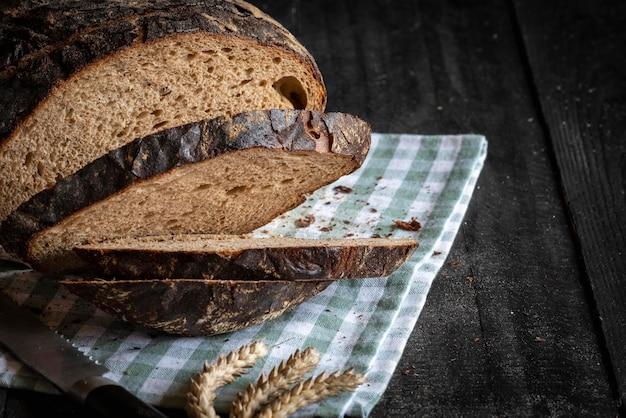 close up of freshly baked rye bread loaf on a wooden cutting board