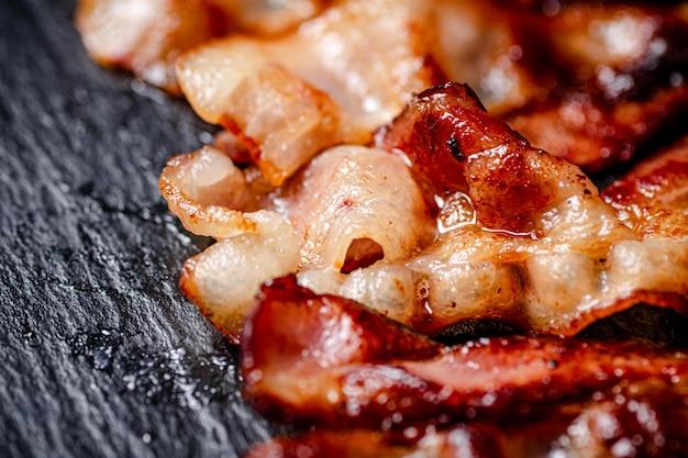 Close-up shot of bacon sizzling in a pan