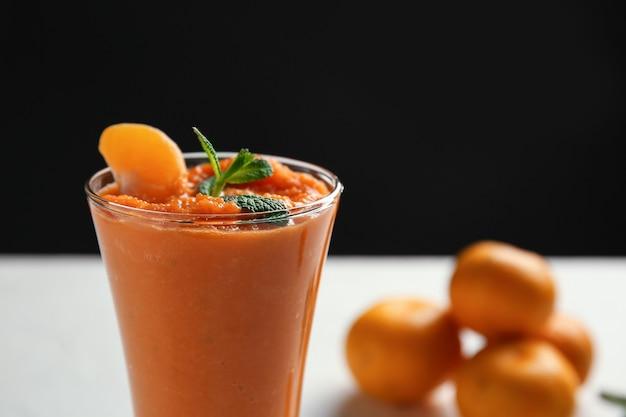 Close-up shot of a glass of orange smoothie
