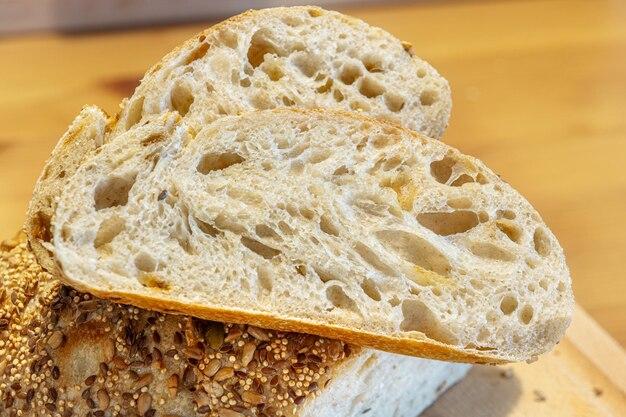close up shot of slicing a loaf of sourdough bread