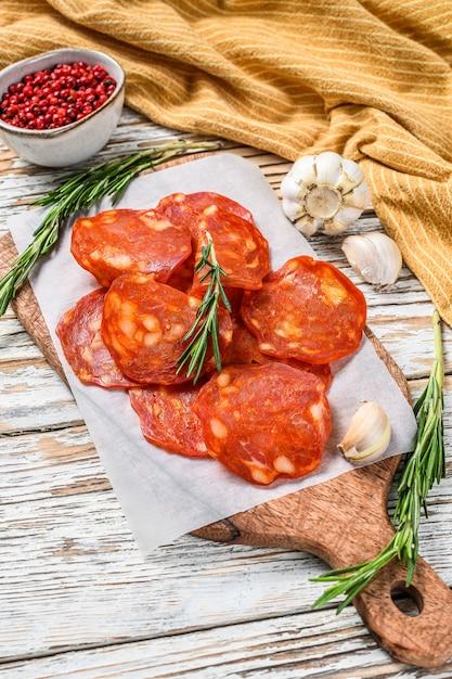 Spanish chorizo being diced on a cutting board