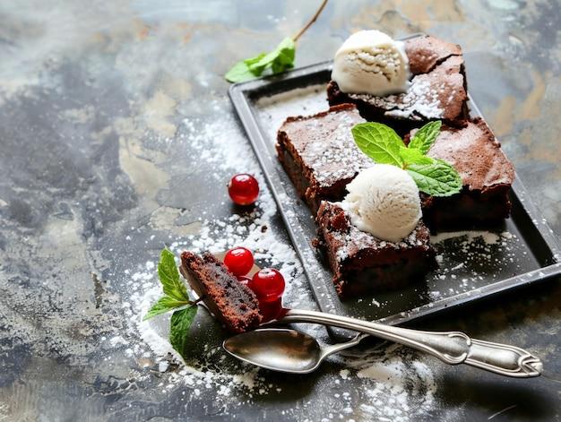 Brownies arranged on a serving platter, with a spoon resting on them