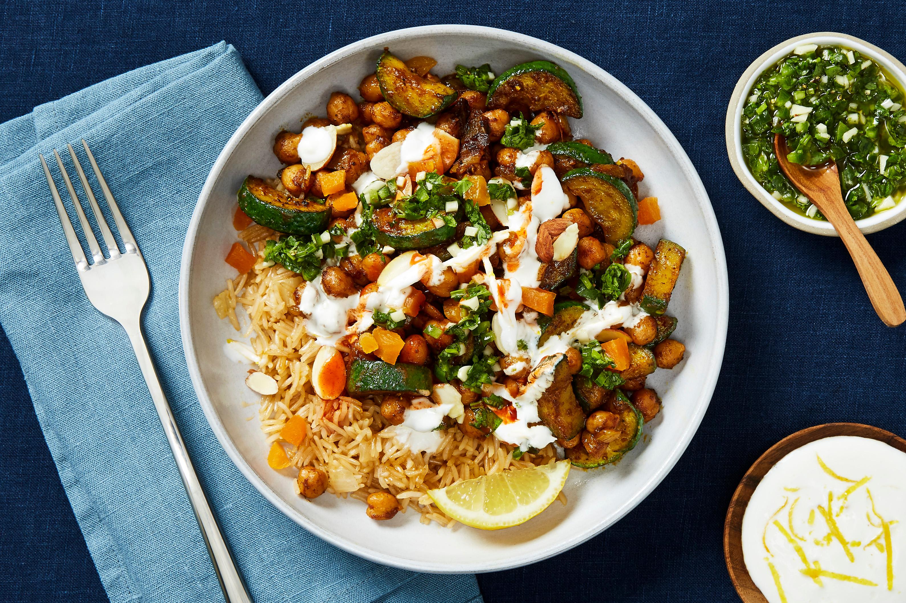 bowl of harissa chickpea curry with apricots and almonds