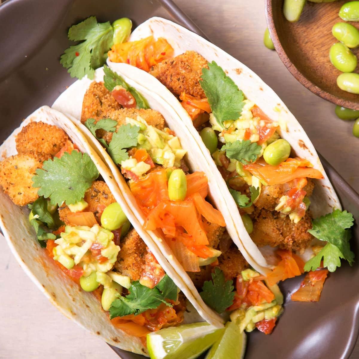Close-up shot of vibrant Kimchi Orange Salad Tacos with fresh cilantro garnish