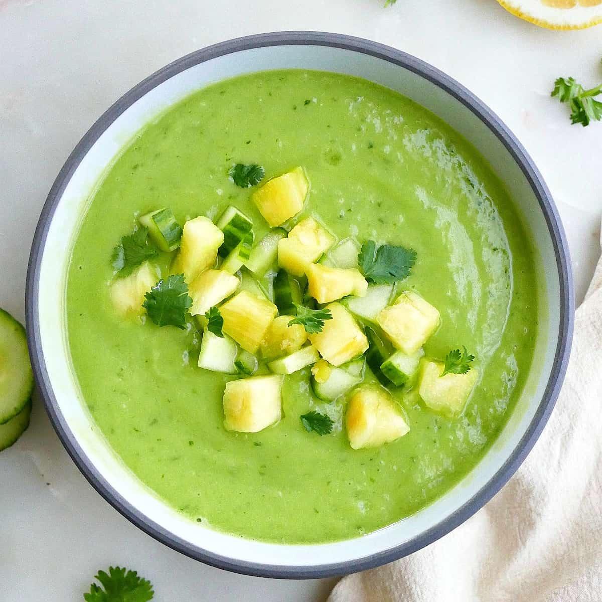 a bowl of creamy green keto avocado and cucumber soup