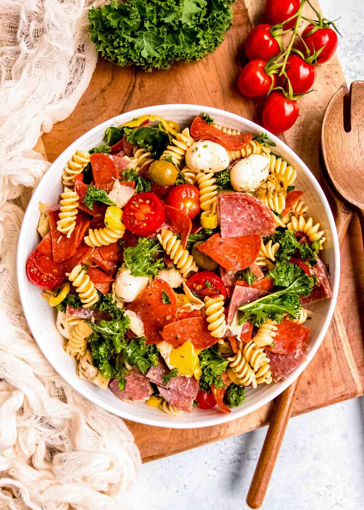 overhead shot of a colorful buffalo mozzarella and tomato pasta salad in a white bowl