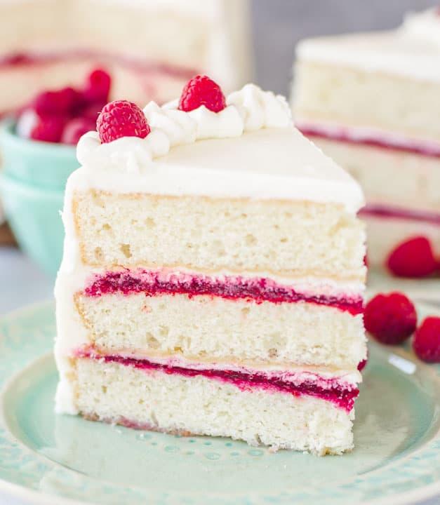 slice of raspberry cake with white frosting