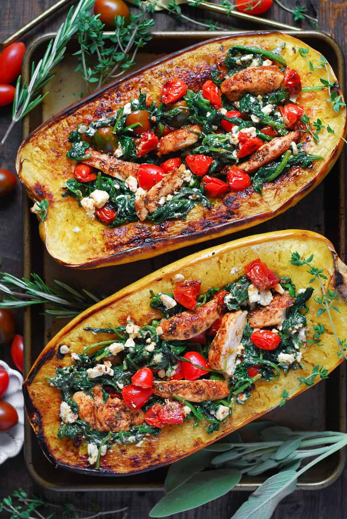 Overhead shot of ingredients laid out for spaghetti squash and spinach stuffed chicken breast