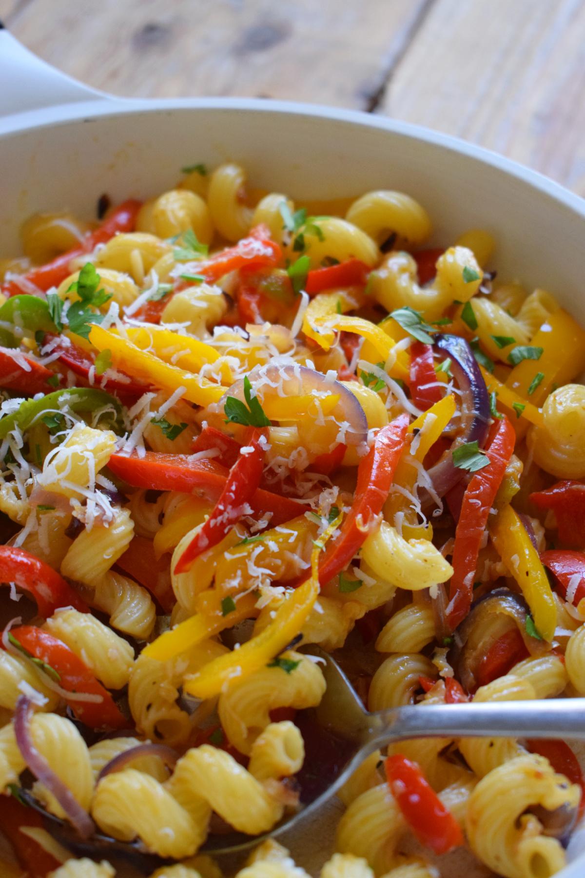 Close up of a bell pepper pasta salad being served