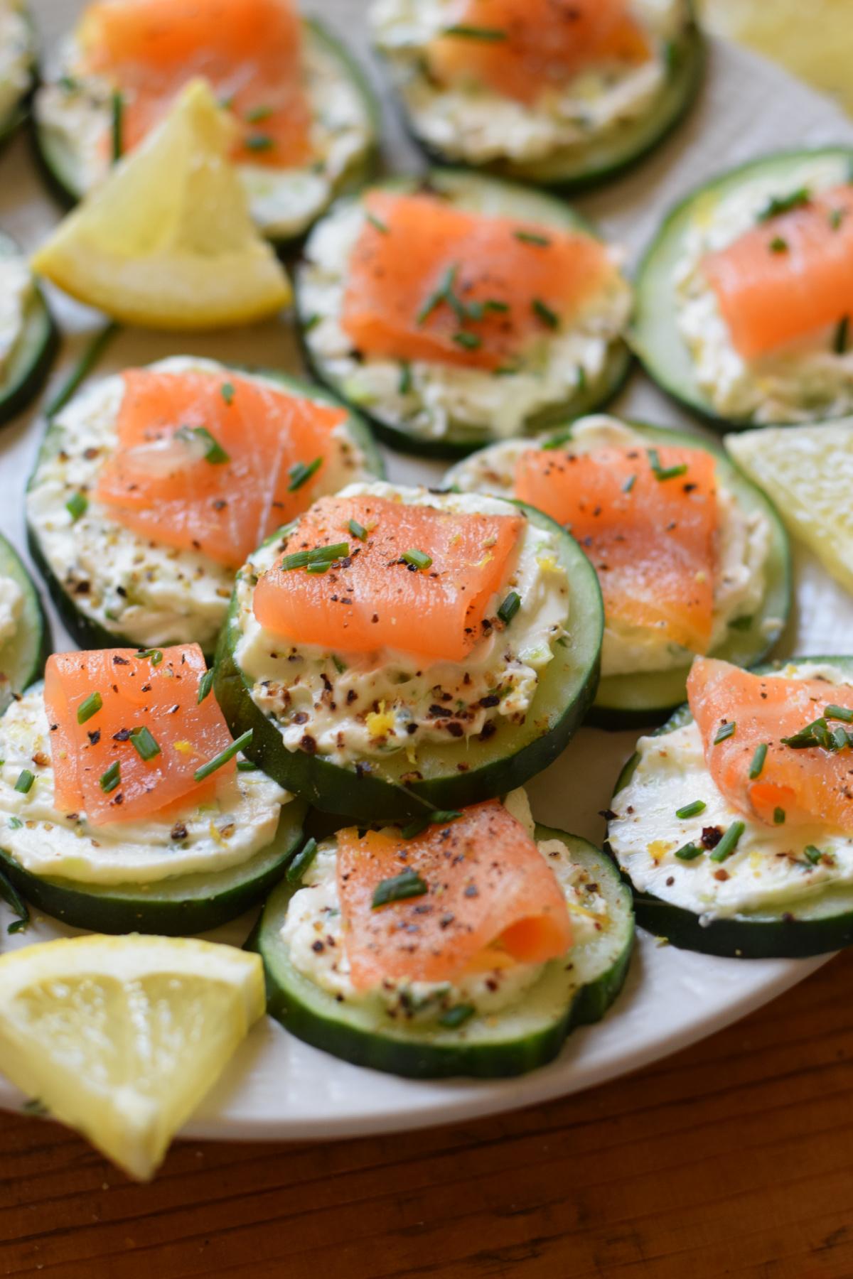 close up of smoked salmon and cucumber skewers on a serving platter
