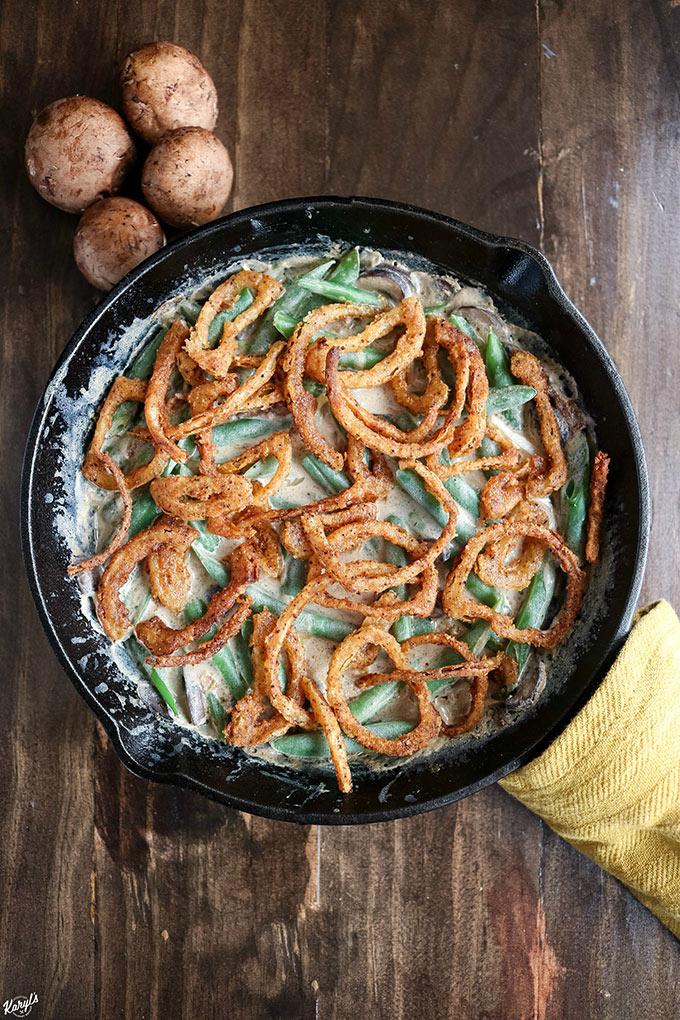 Skillet green bean casserole baking in the oven, golden brown crispy topping