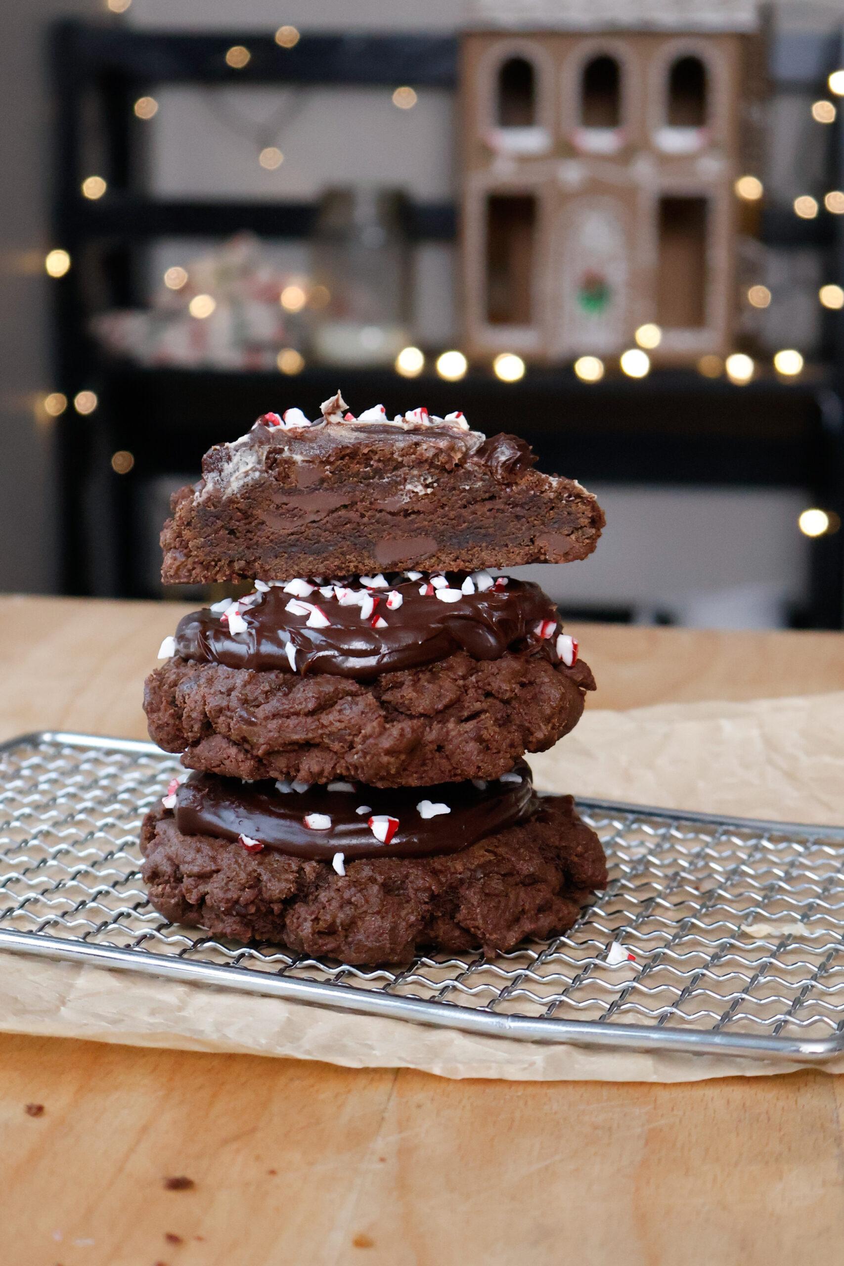 Stack of cocoa peppermint cookies with visible crunchy edges on a cooling rack
