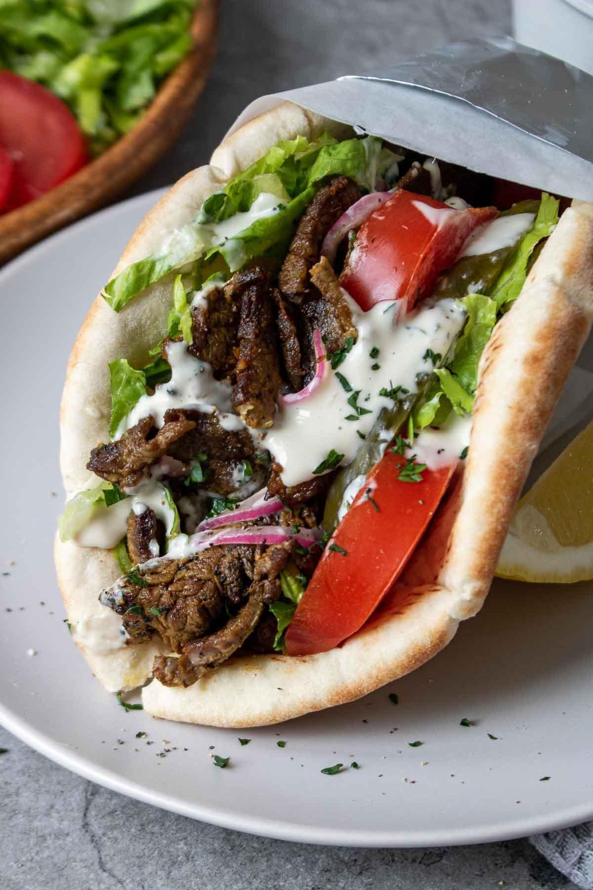 close up of a prepared steak shawarma wrap