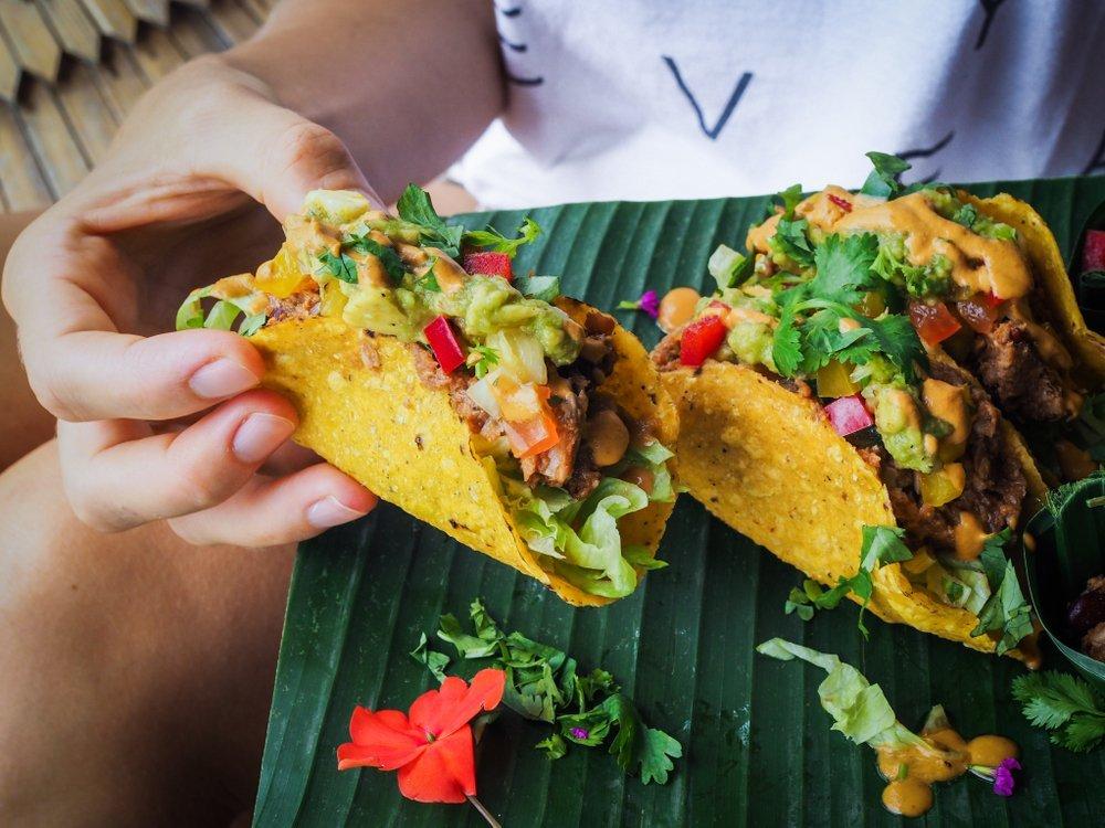 someone eating jackfruit taco with cheese