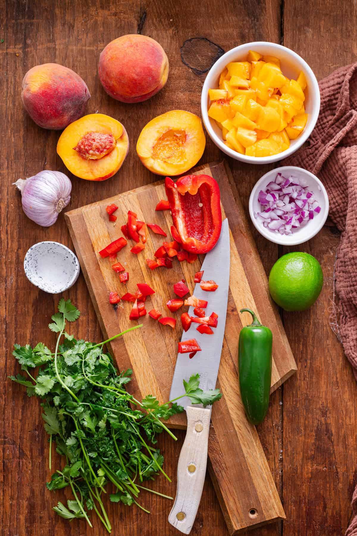 ingredients for peach salsa on cutting board
