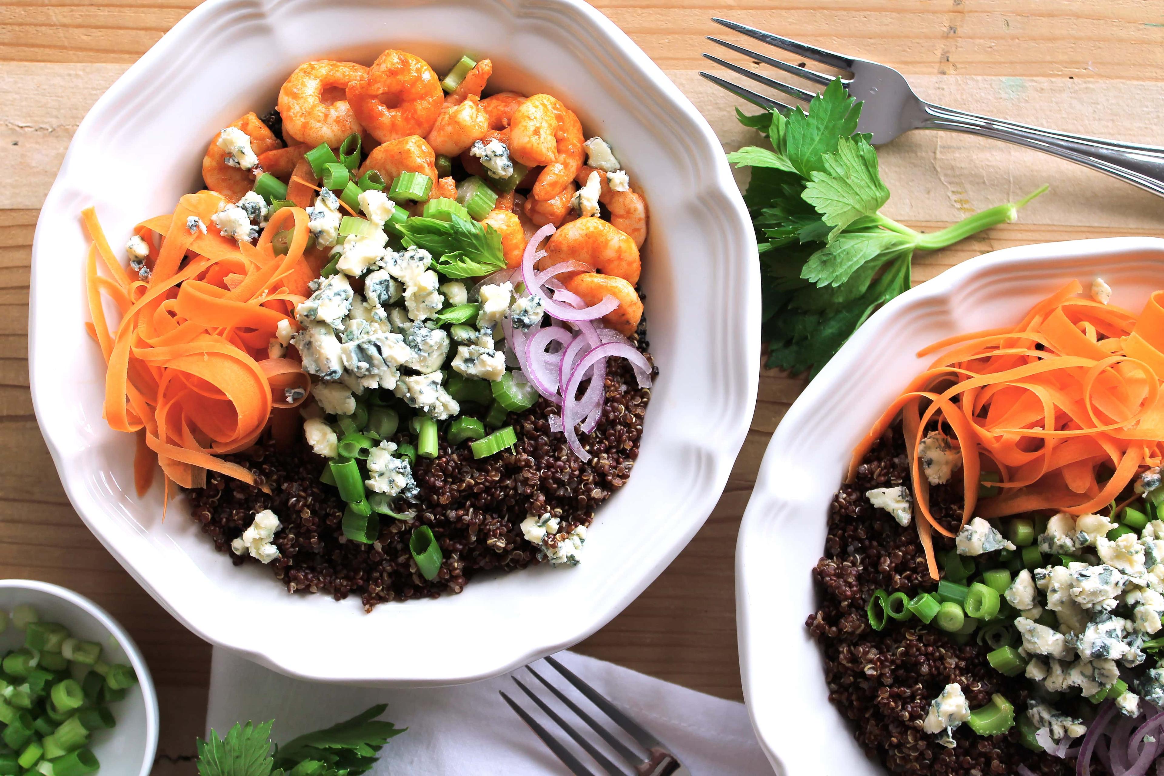 Overhead shot of a vibrant buffalo shrimp protein bowl with celery ranch