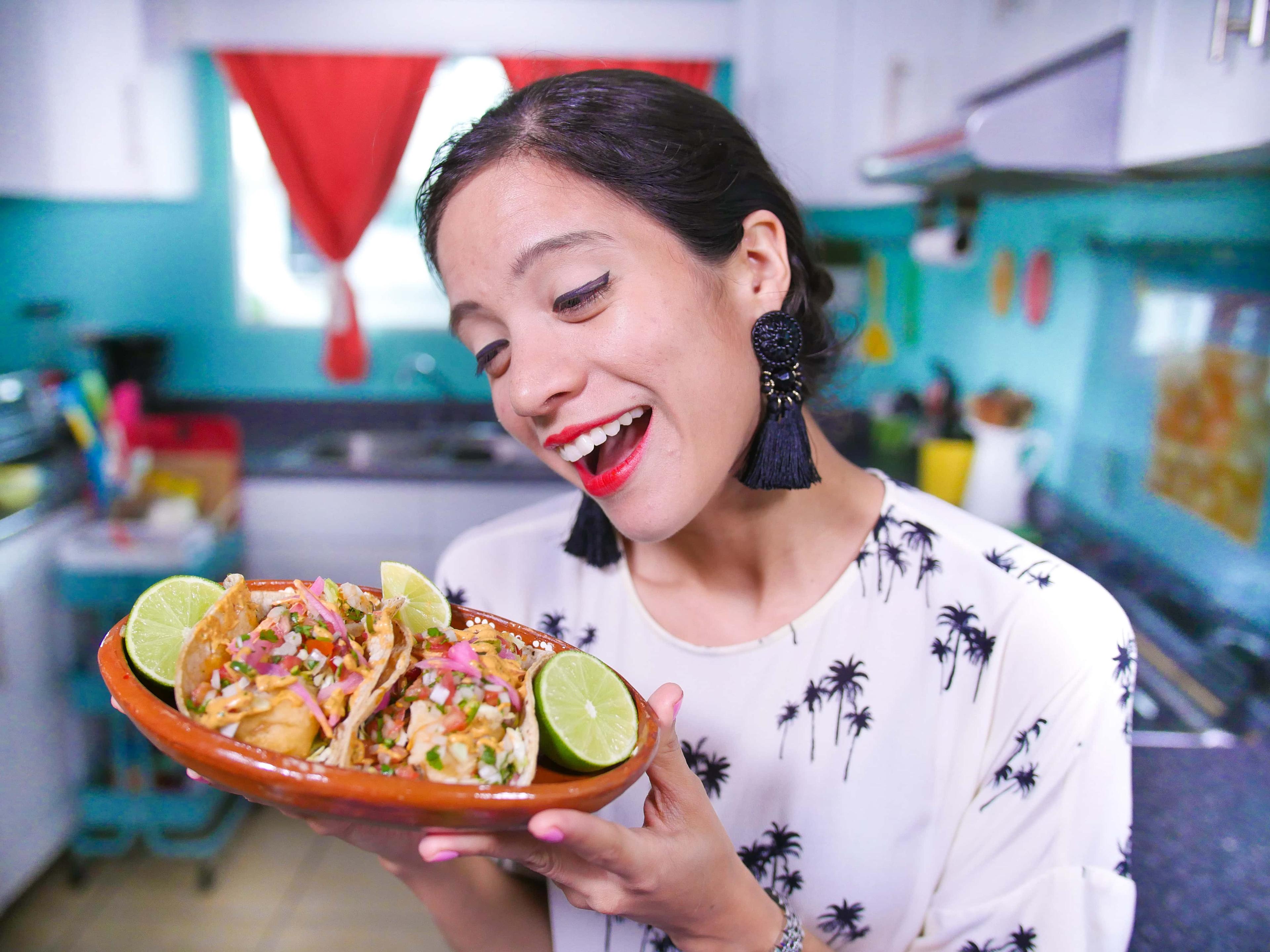 Person enjoying seafood tacos