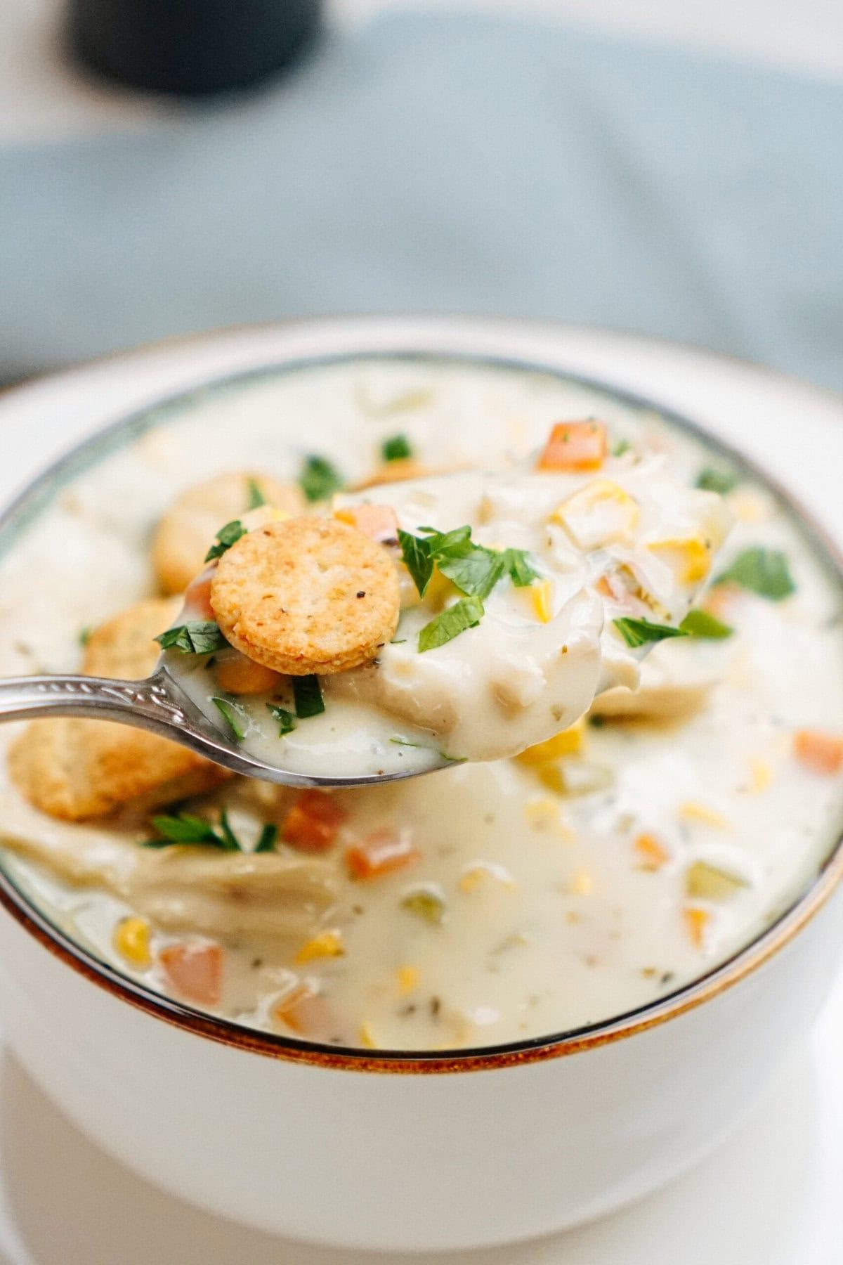 creamy chicken corn chowder in a bowl garnished with fresh herbs