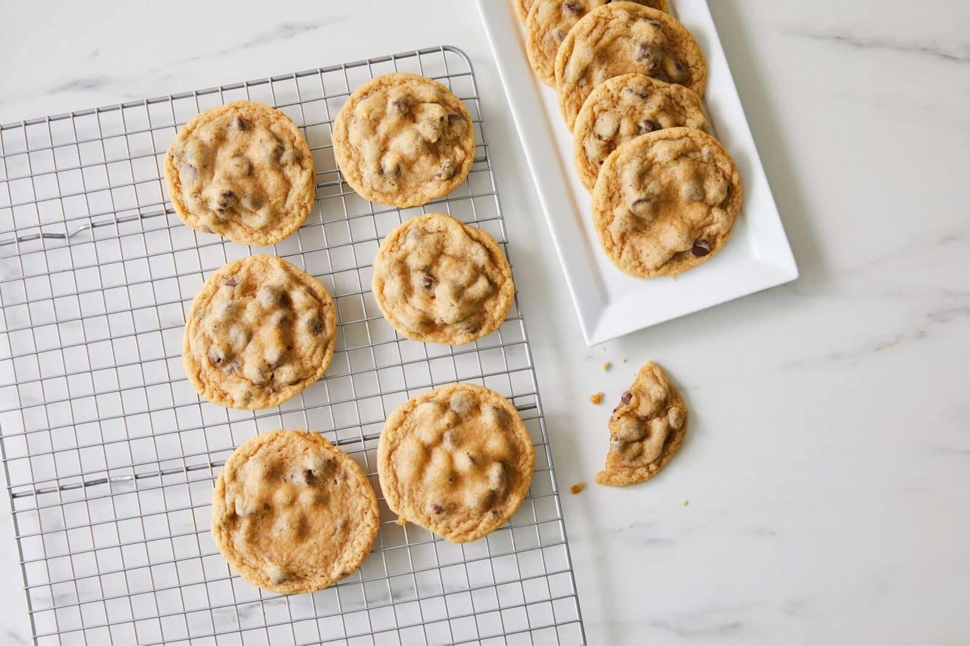 freshly baked butter cookies cooling on a wire rack, ready for decorating