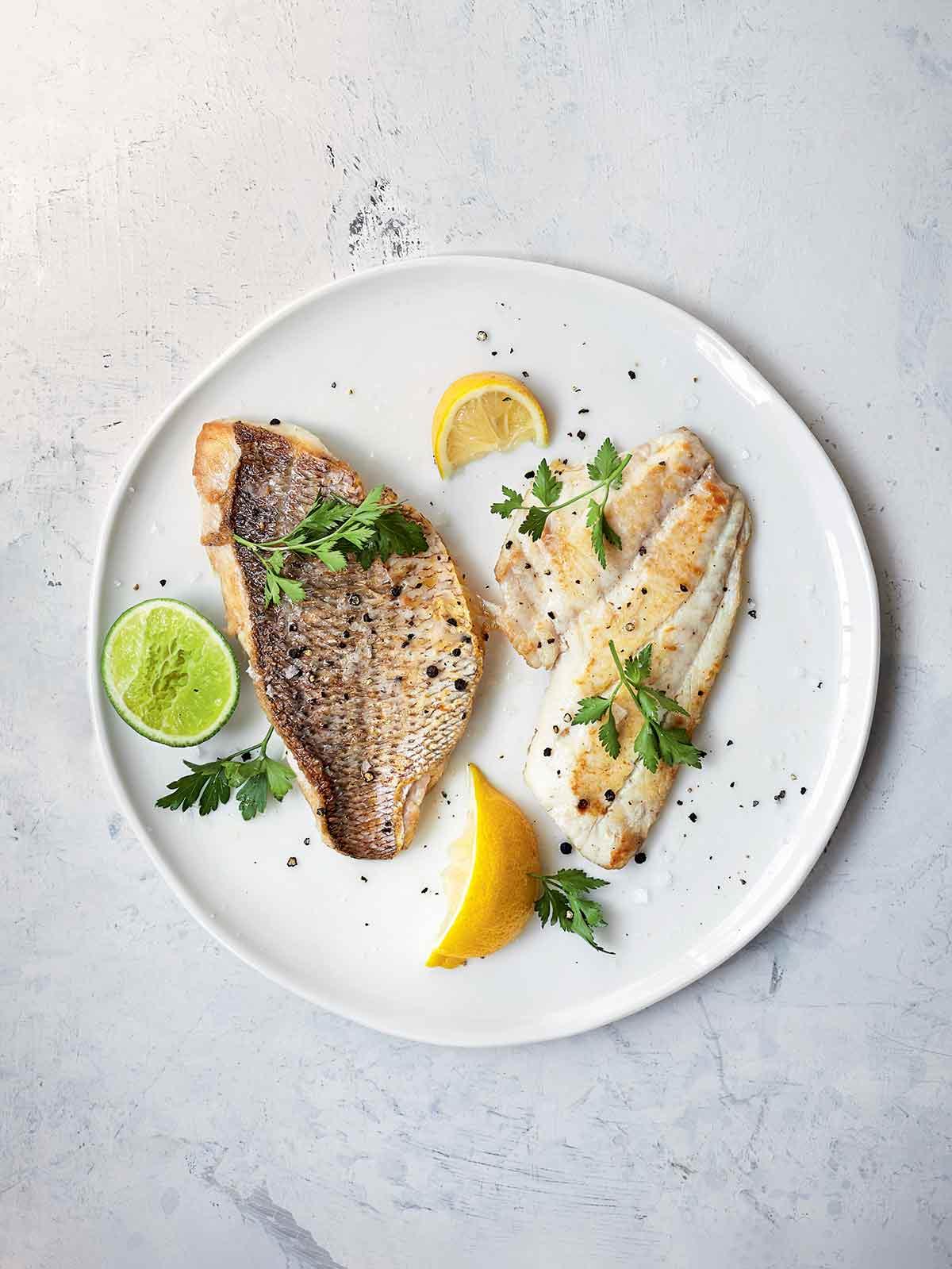 Close-up of a pan searing fish fillets with a golden crust