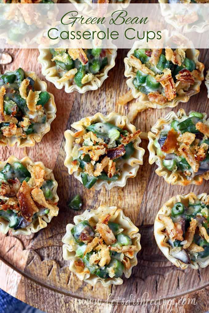 Baked green bean casserole cups on a serving platter, cozy Thanksgiving table setting with autumn leaves