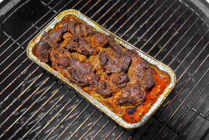 Close-up shot of beef shawarma cooking on a grill pan, sizzling and aromatic