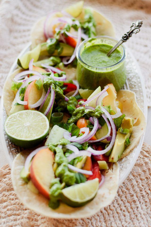 A table set with gravlax tacos, garnished with lime wedges and cilantro sprigs