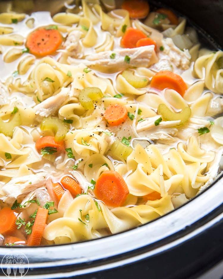 close-up of homemade chicken noodle soup with visible vegetables and noodles