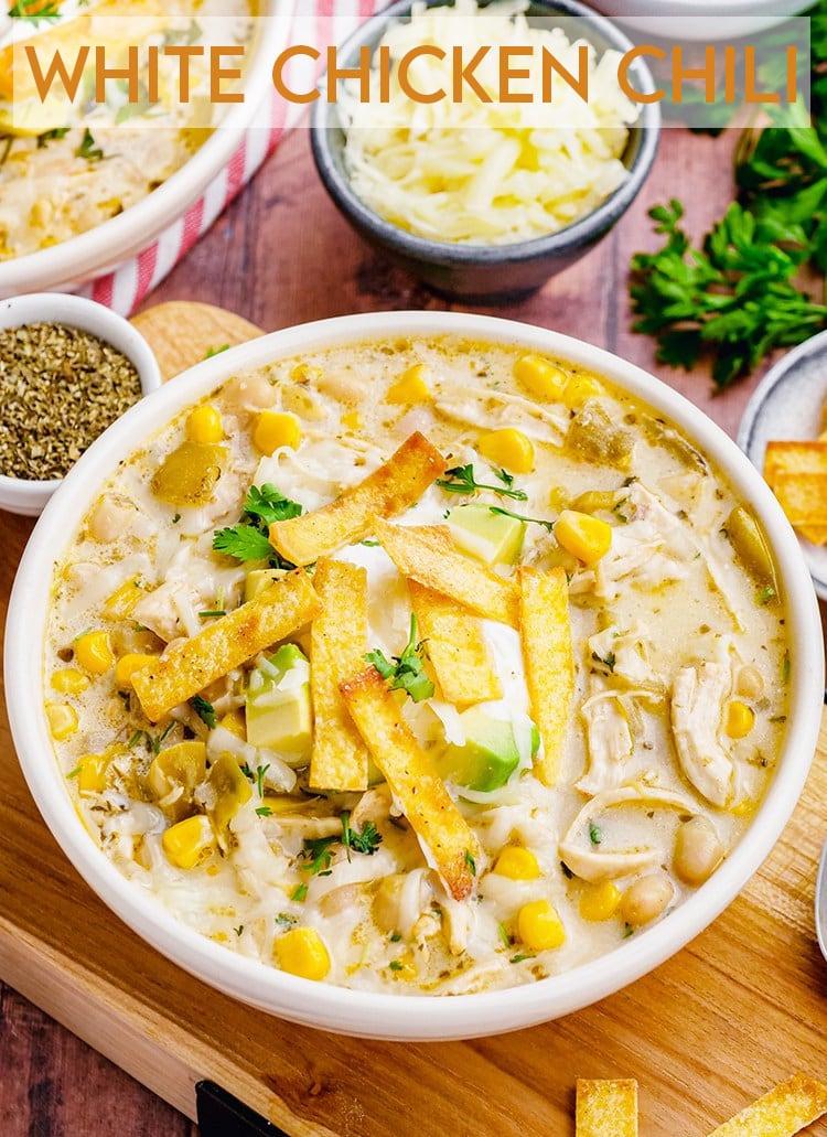 bowl of white chicken chili topped with cilantro and sour cream