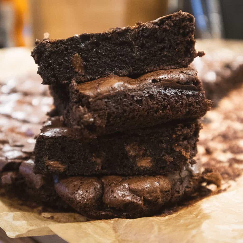 close-up shot of a single brownie with a gooey center and visible chocolate chips