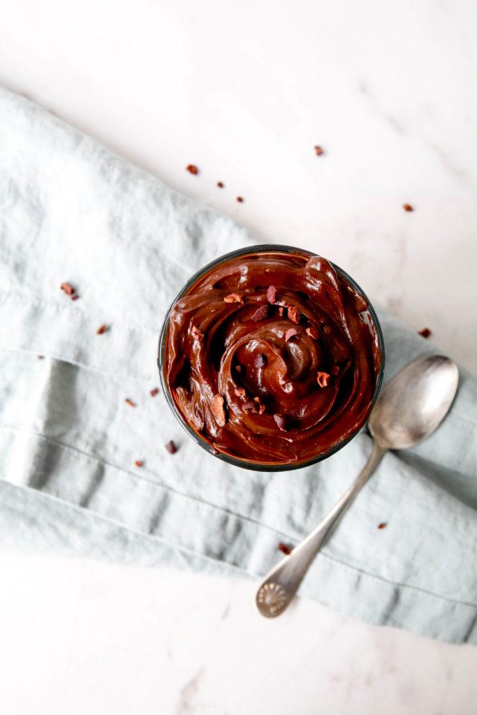 close-up of a spoonful of chocolate avocado mousse being lifted