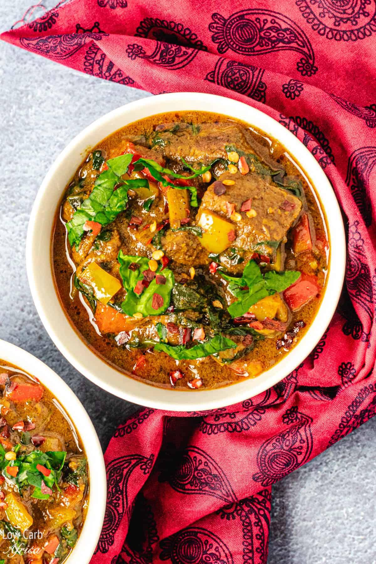 lamb curry with coconut milk and spinach served in a bowl