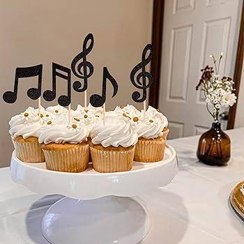musical note cupcakes displayed on a cake stand